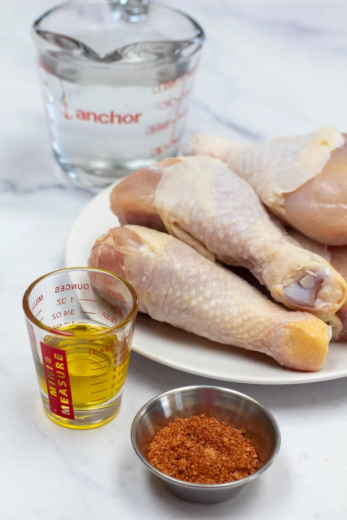 Tall image of ingredients needed for instant pot chicken drumsticks.