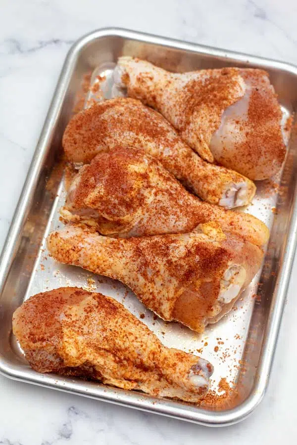 Process image 1 showing seasoned chicken legs.