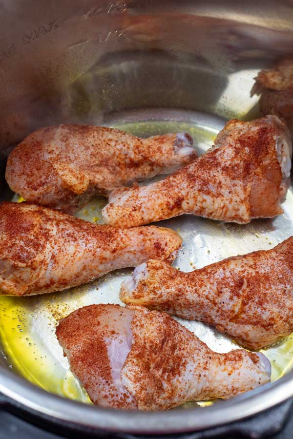 Process image 2 showing seasoned chicken legs in the instant pot.