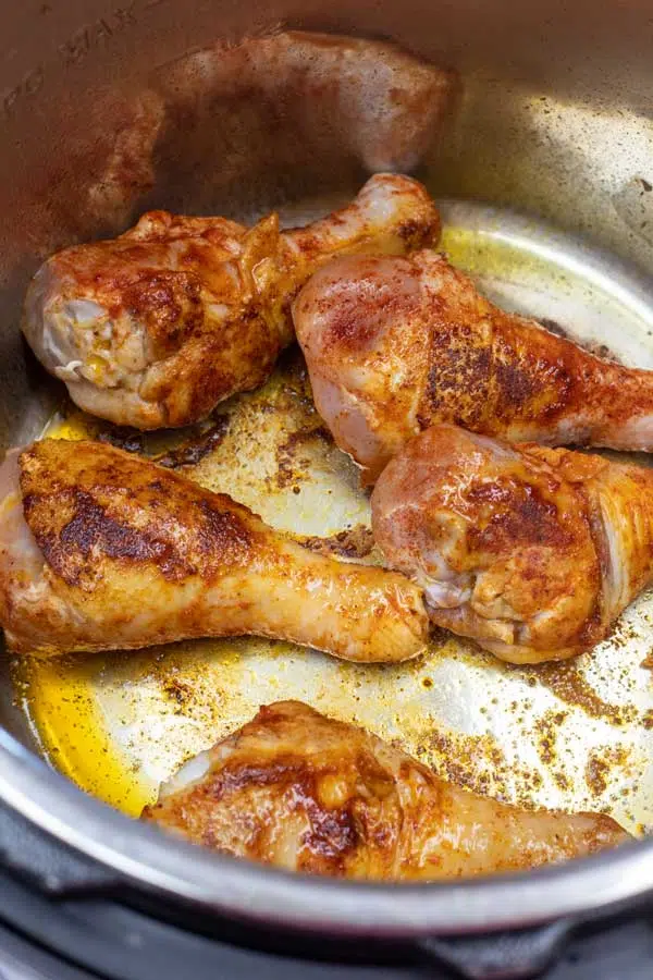 Process image 3 showing chicken legs searing in the instant pot.