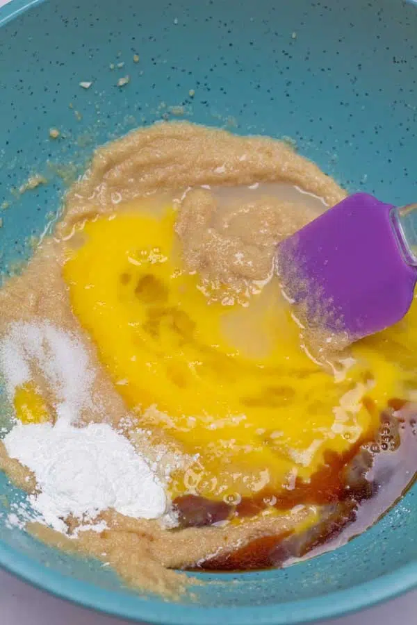 Process image 3 showing added egg and vanilla to the creamed together sugars and butter.