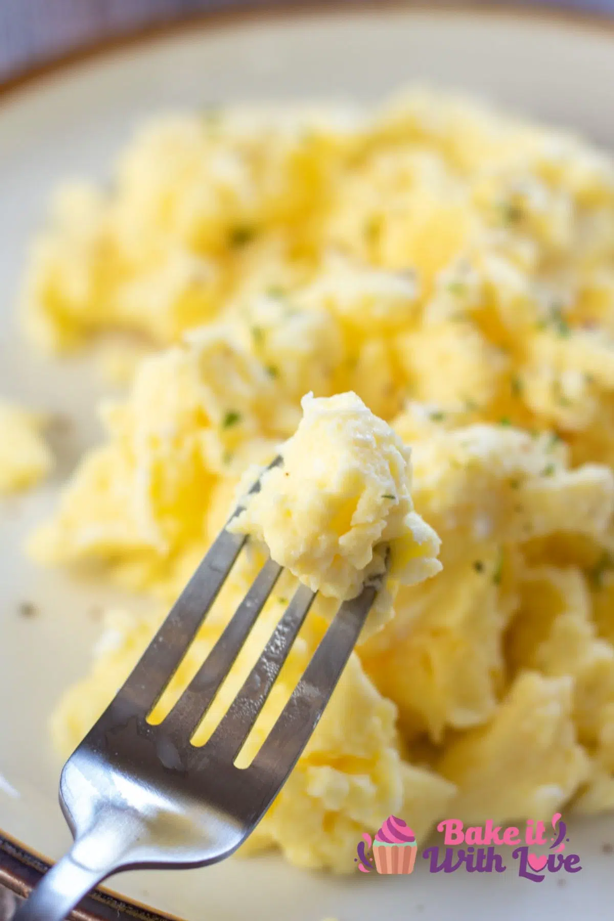 Tall image of microwaved scrambled eggs on a plate.