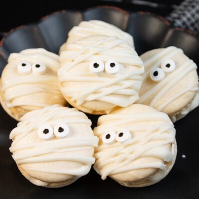 Vanilla mummy macarons with buttercream filling and candy eyes.