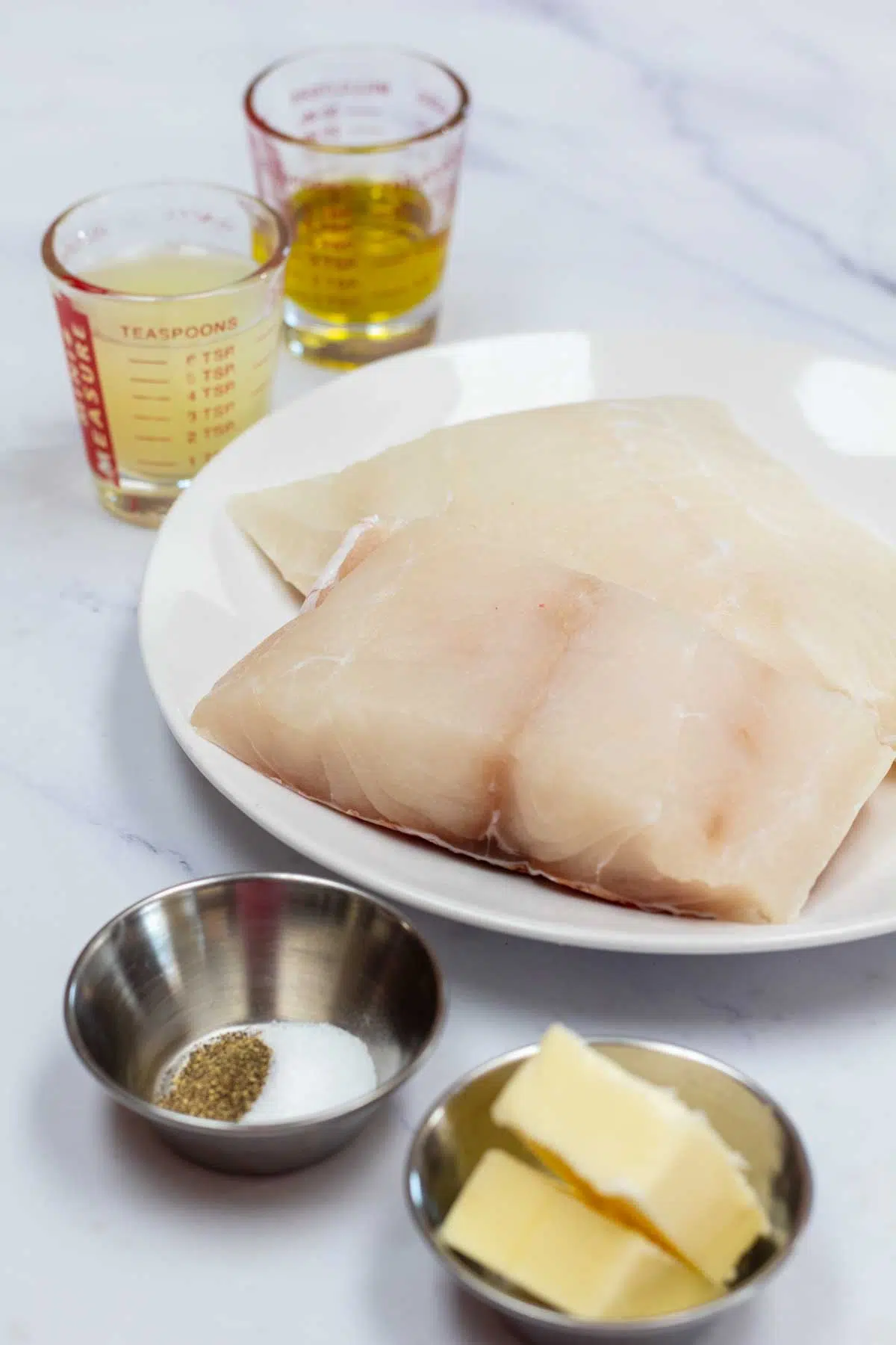 Tall photo of ingredients needed for pan seared red snapper.
