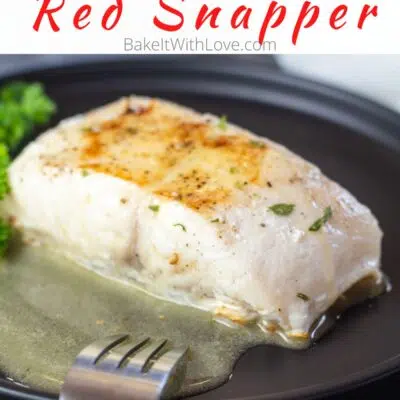 Pin image with text of pan seared red snapper on a black plate with parsley.