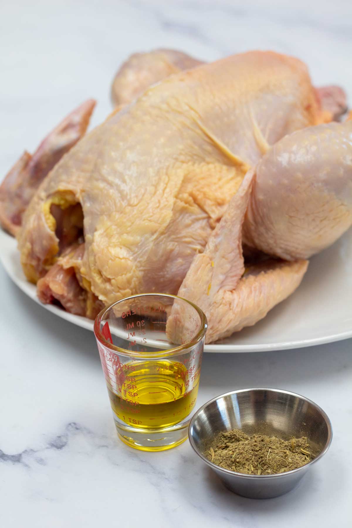 Tall image of ingredients for making roasted sasso chicken.