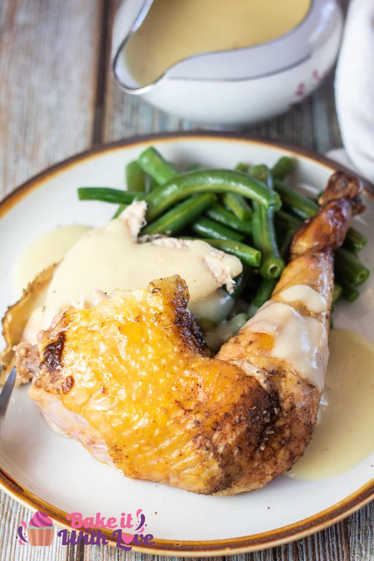 Tall image of sasso chicken leg quarter on a plate.