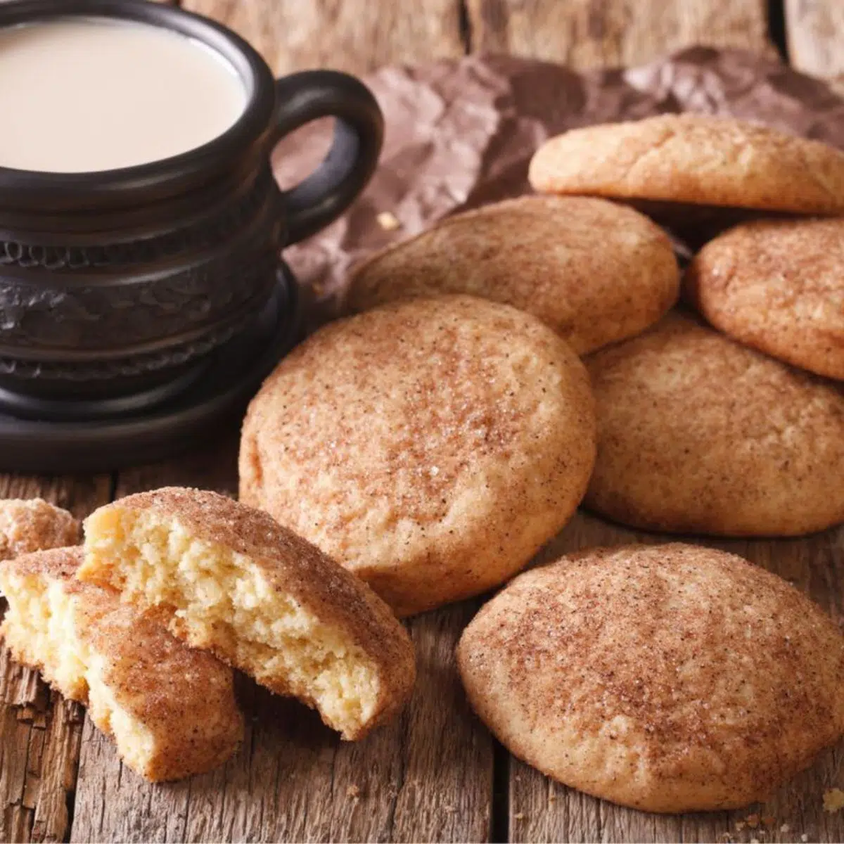 Square image of snickerdoodle cookies next to a cup of coffee.