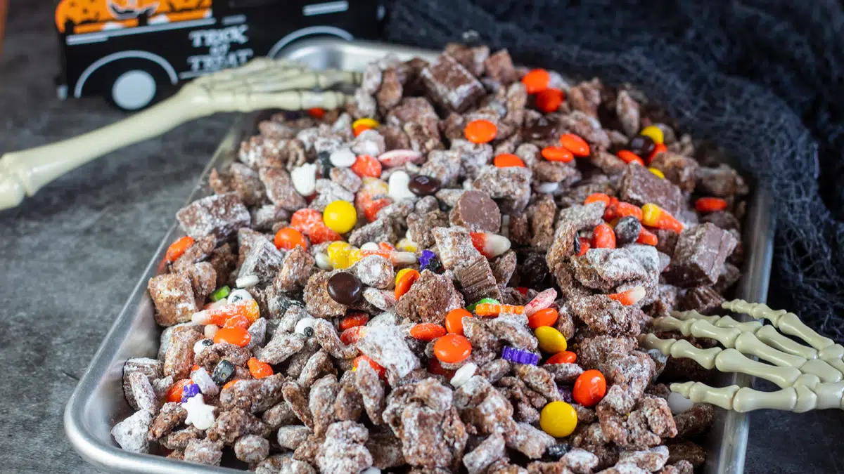 Wide image of a tray of Halloween muddy buddies.