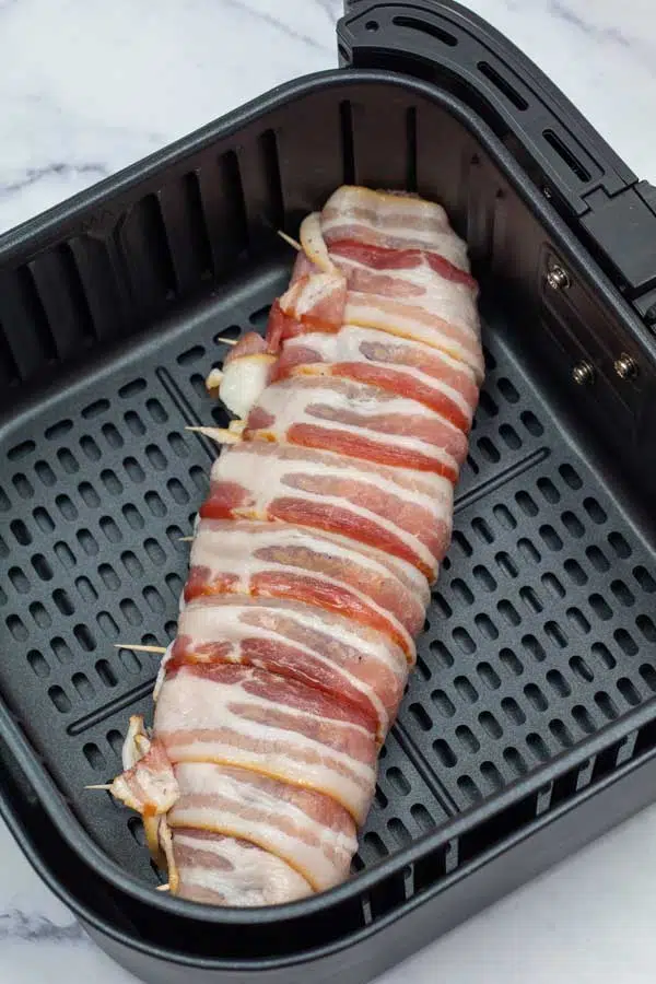 Process image 5 showing pork tenderloin in air fryer basket.