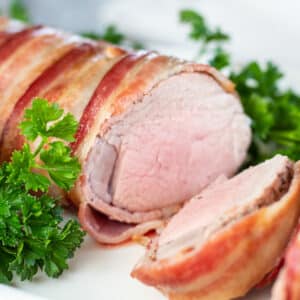 Close up square image of air fryer bacon wrapped pork tenderloin.