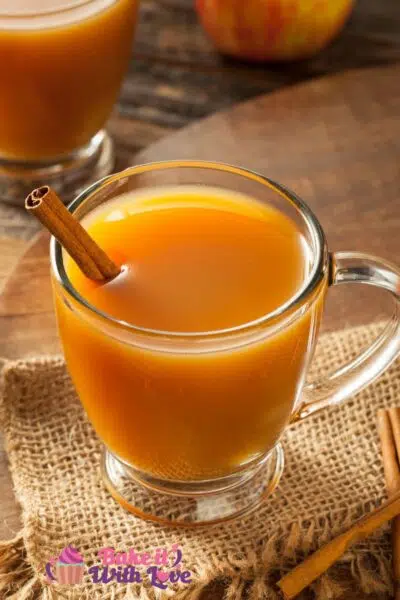 Tall image of apple cider in a glass mug.