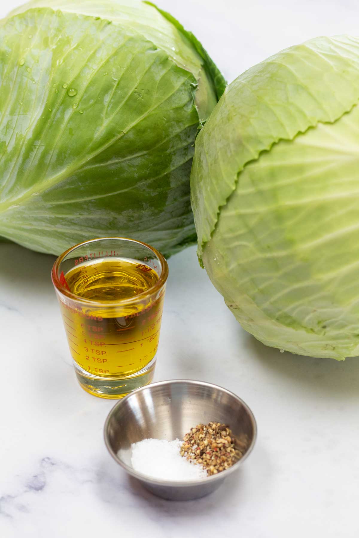 Tall image of ingredients for baked cabbage steak.