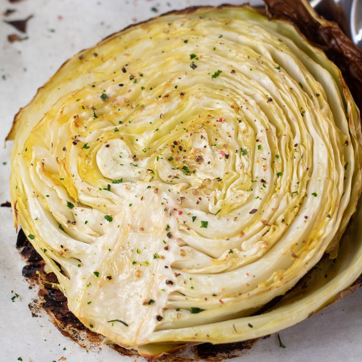 Square image of baked cabbage steak.