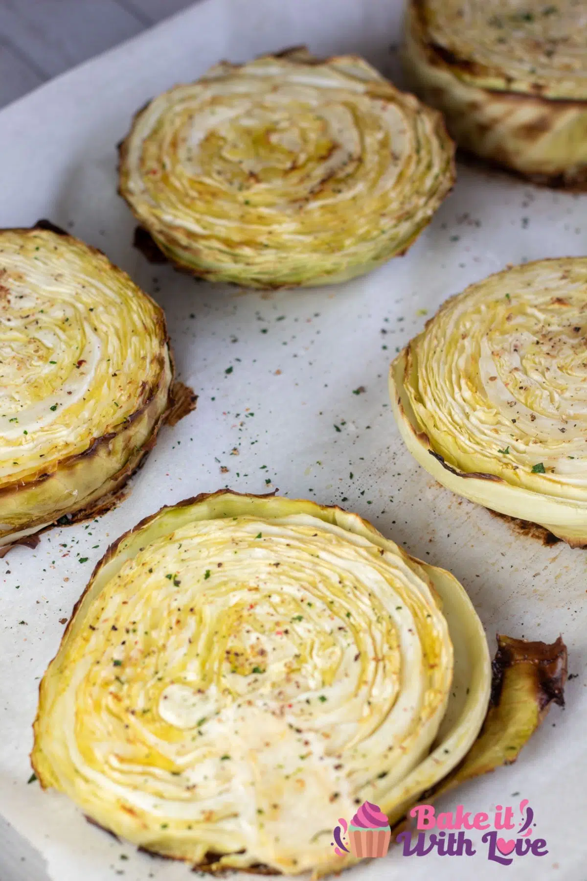 Tall image of baked cabbage steaks.
