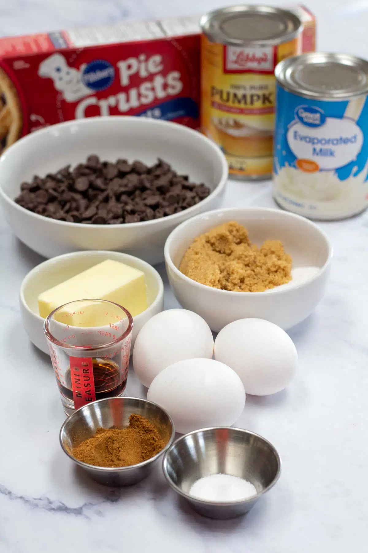 Tall image showing ingredients for chocolate pumpkin pie.