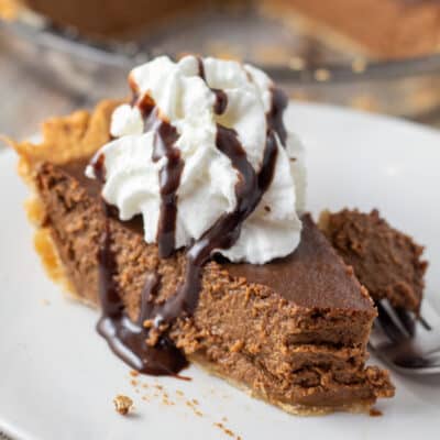 Square image of chocolate pumpkin pie slice on a white plate