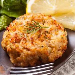 Square image of a crab cake on a plate.