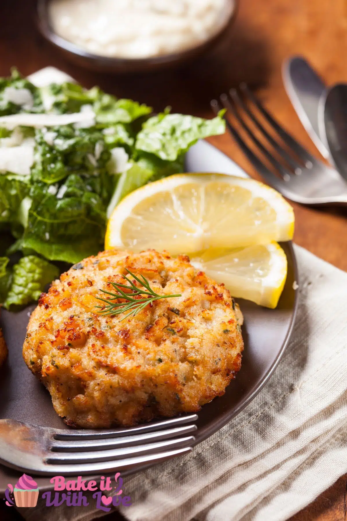 Tall image of a crab cake on a plate.