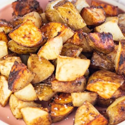 Square image of onion soup mix roasted potatoes on a plate.