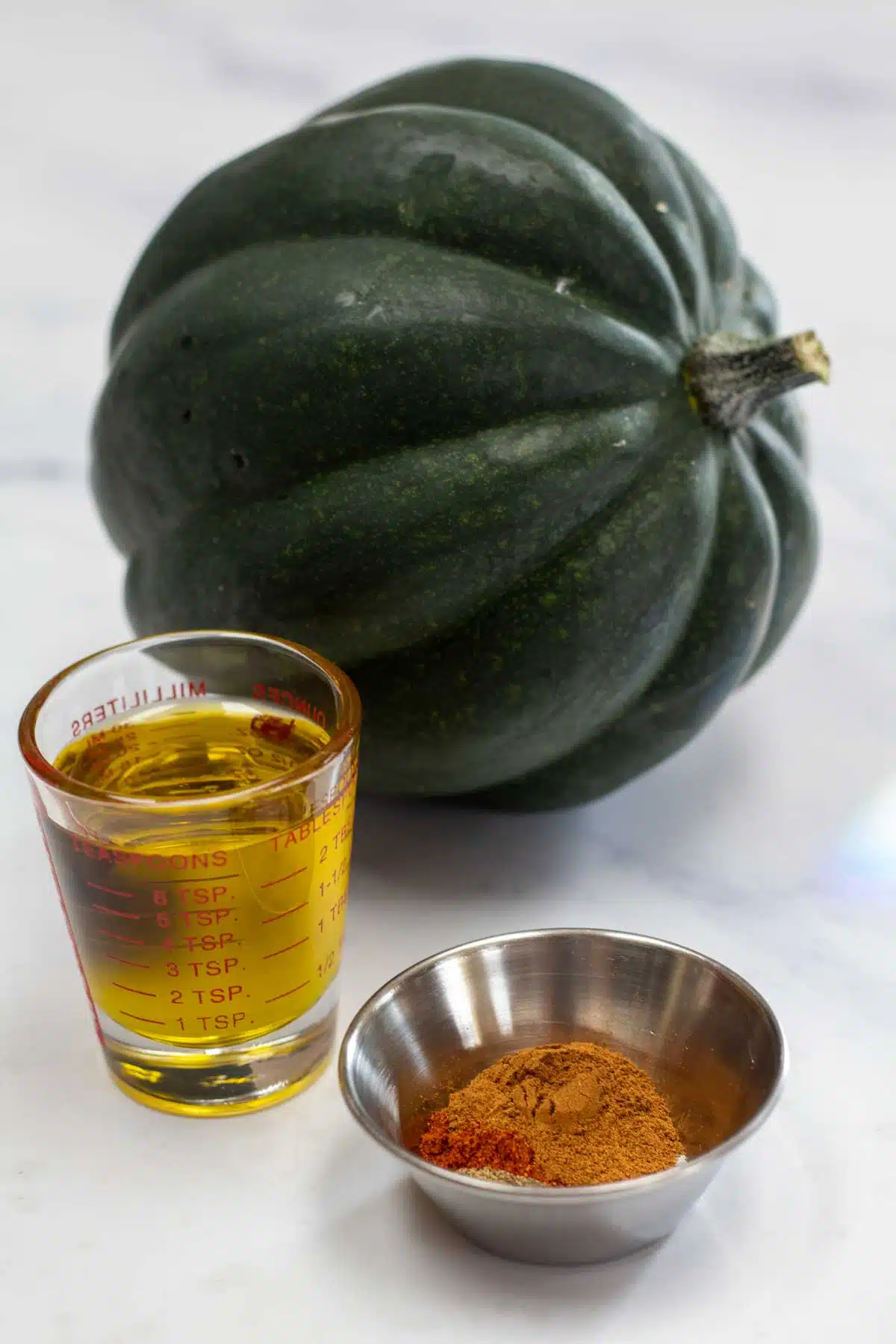 Tall image of grilled acorn squash ingredients.