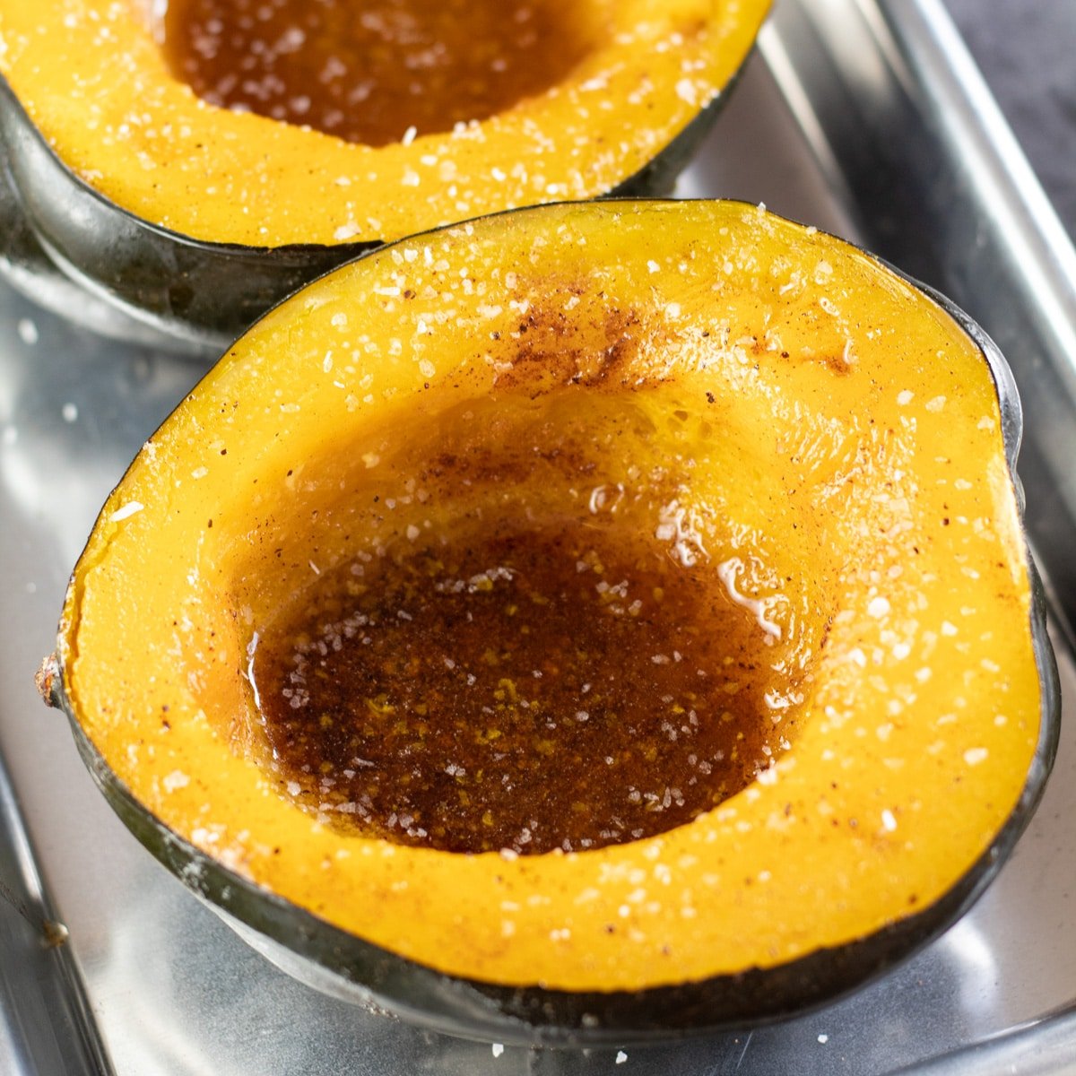 Pumpkin leaves cooked in peanut butter is seen in a clay pot at a