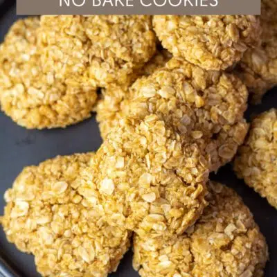 Pin image with text of no bake pumpkin cookies on a black plate.