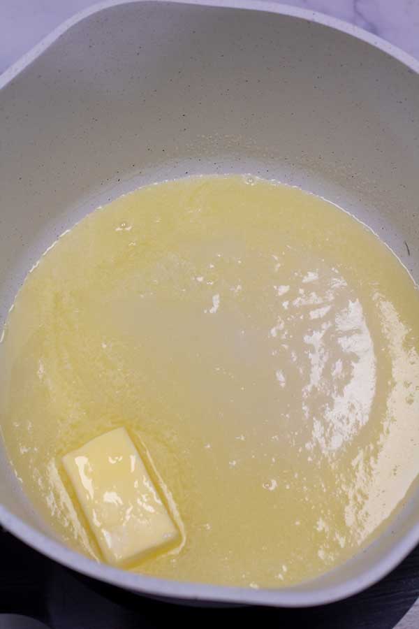 Process image 2 showing melting butter in a cooking pot.