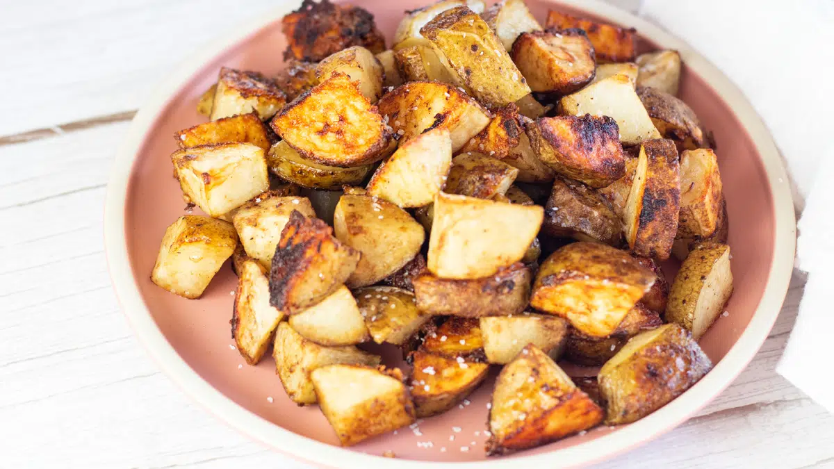 Wide image of onion soup mix roasted potatoes on a plate.