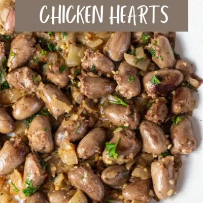 Pin image with text showing pan seared chicken hearts in a frying pan.