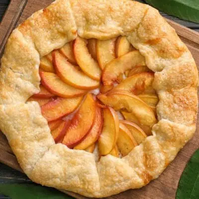 Square image showing a peach galette.