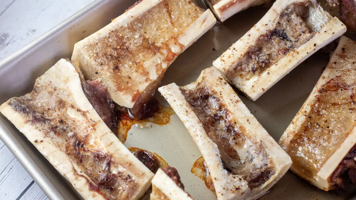 Wide image of a tray with roasted beef bone marrow.