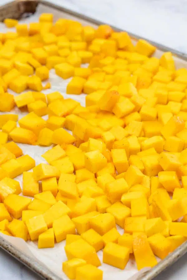 Process image 6 showing butternut squash diced on a baking sheet.