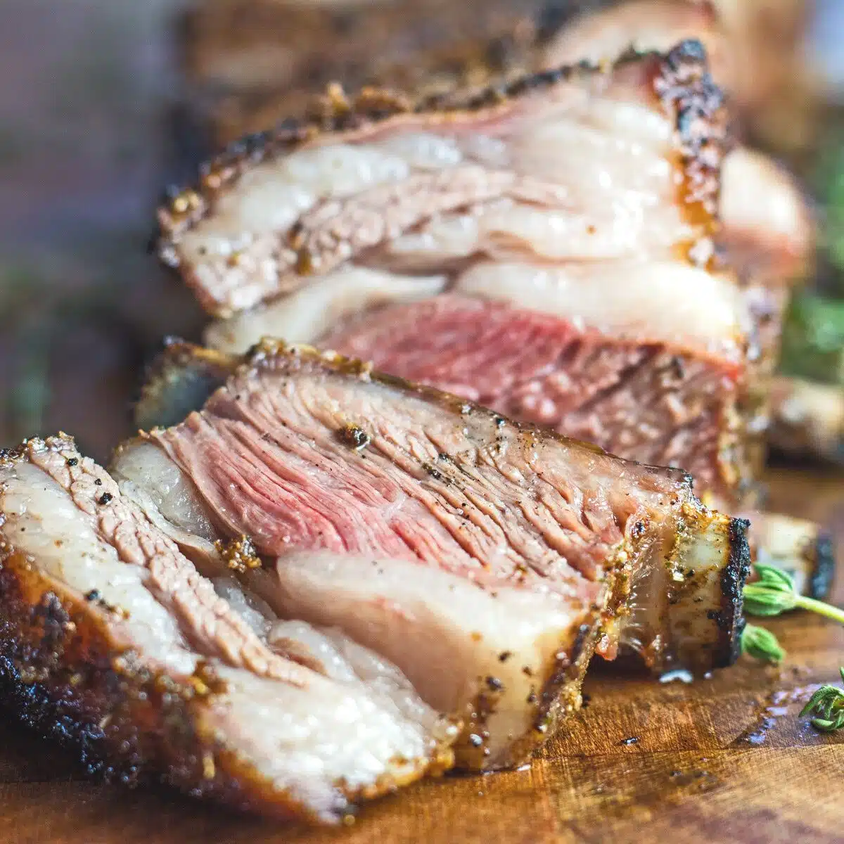 Square image of lamb on a cutting board.