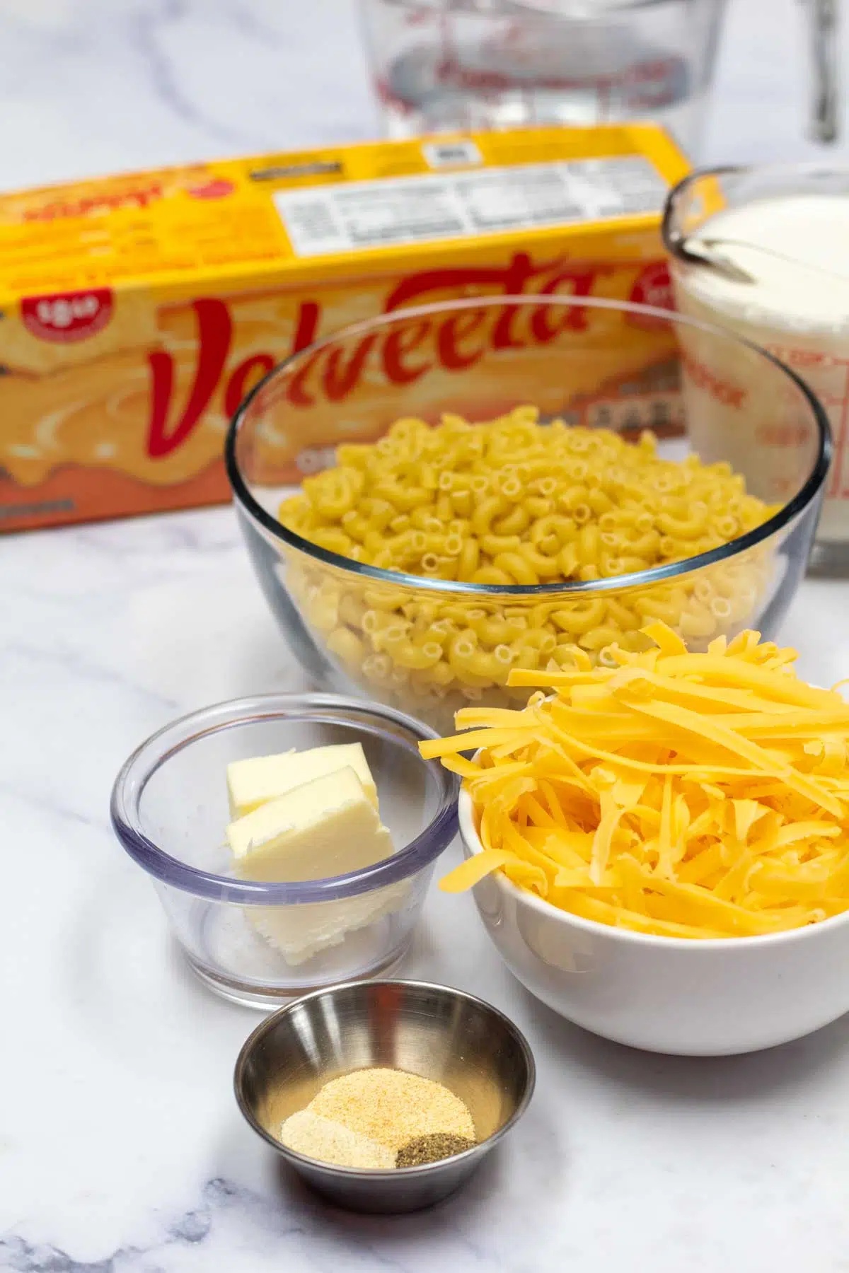 Tall image showing ingredients for Velveeta mac & cheese.