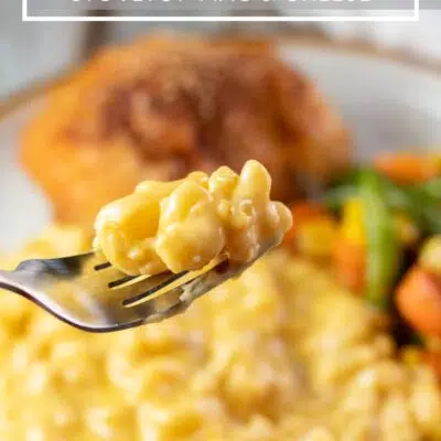 Pin image with text showing velveeta mac & cheese on a plate with chicken and veggies.