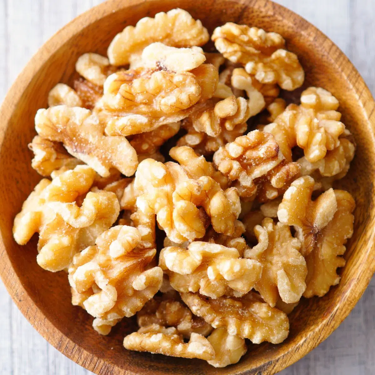 Square image of a bowl of walnuts.