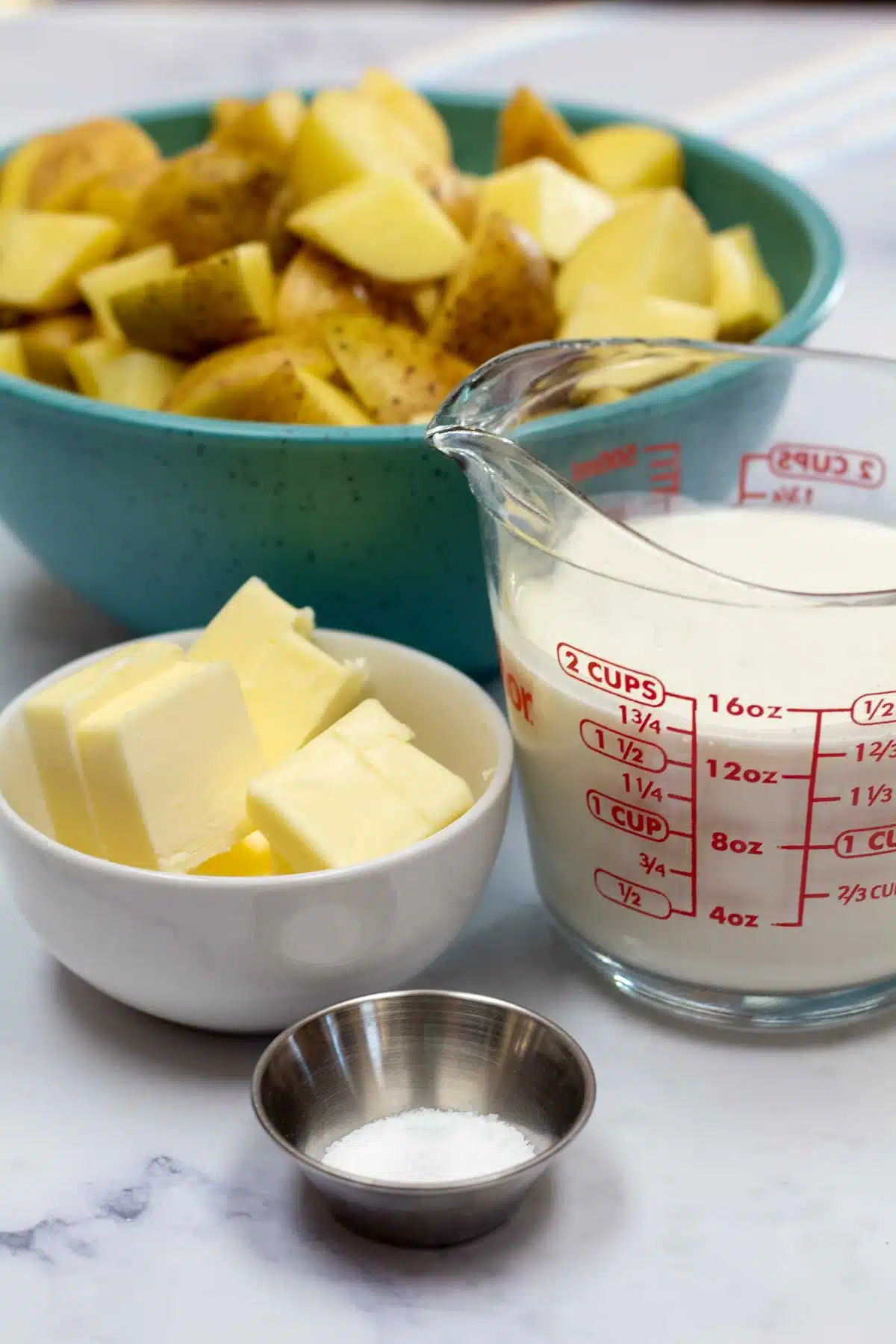 Tall image showing yellow mashed potato ingredients.
