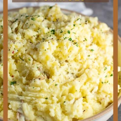 Pin image with text showing a large bowl of yellow mashed potatoes.
