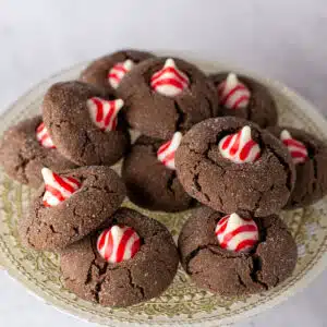 Best chocolate peppermint blossom recipe to bake for the holidays served on a golden plate with light background.