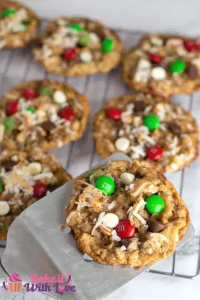 Best Christmas cowboy cookies recipe with freshly baked cookie on metal spatula.