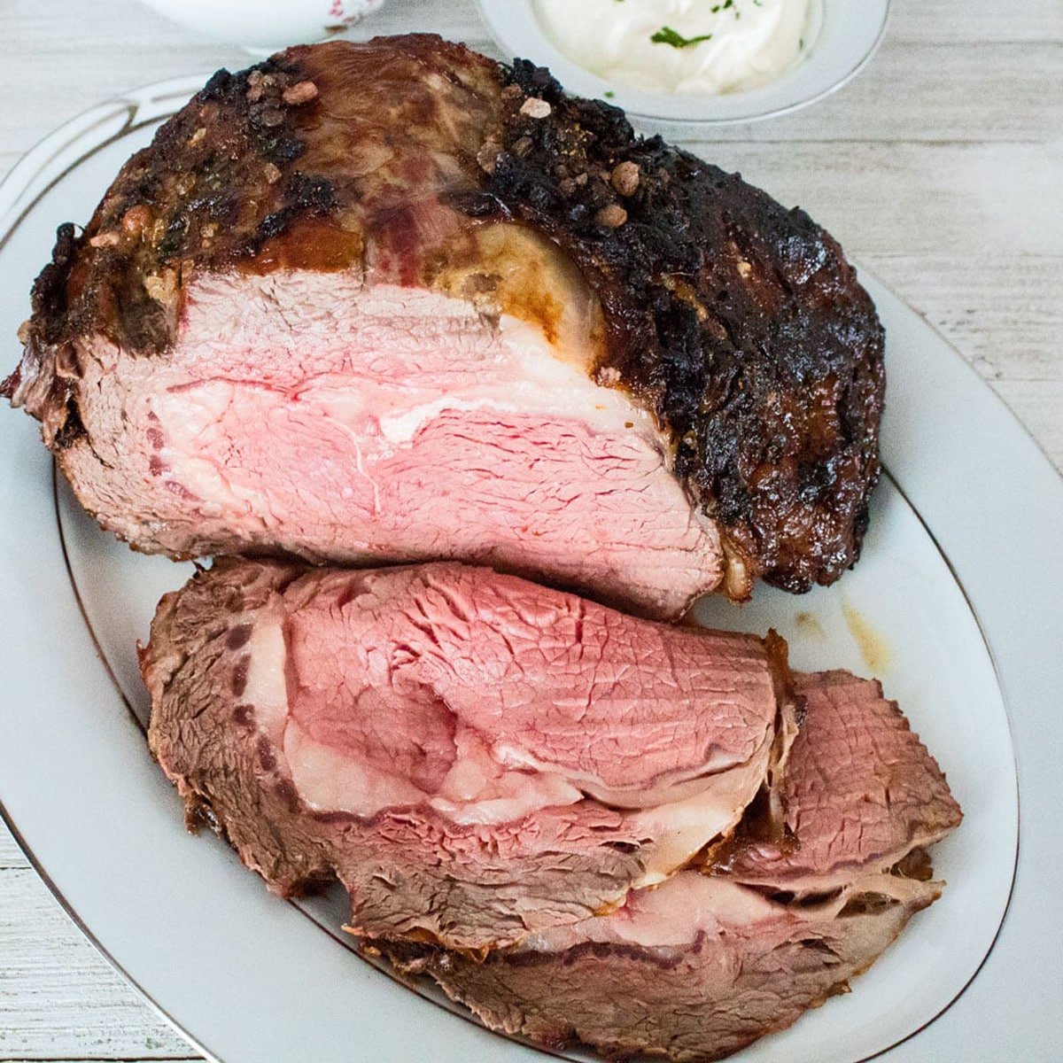 Prime rib roast on a serving plate.
