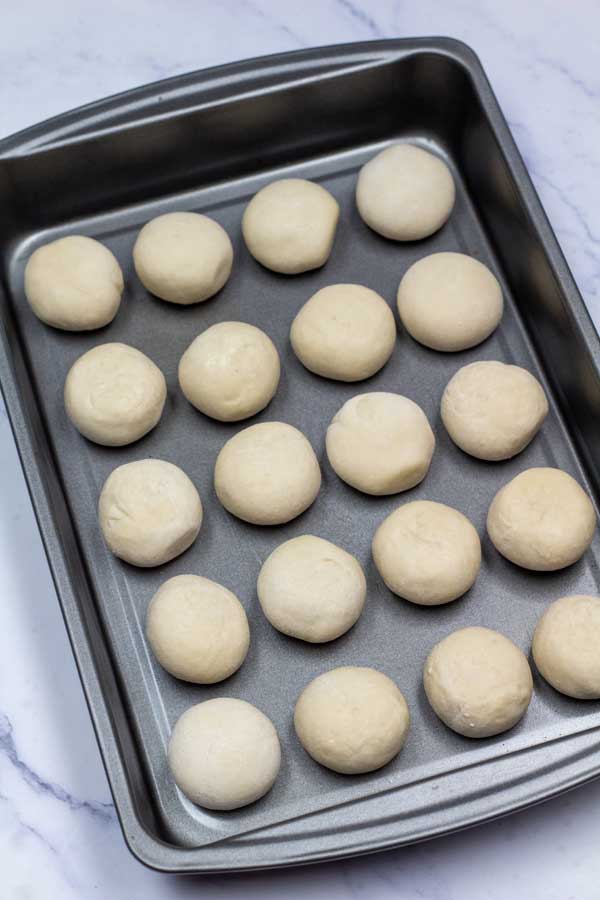 Process image 2 showing Rhodes frozen rolls set into baking dish to thaw and rise.