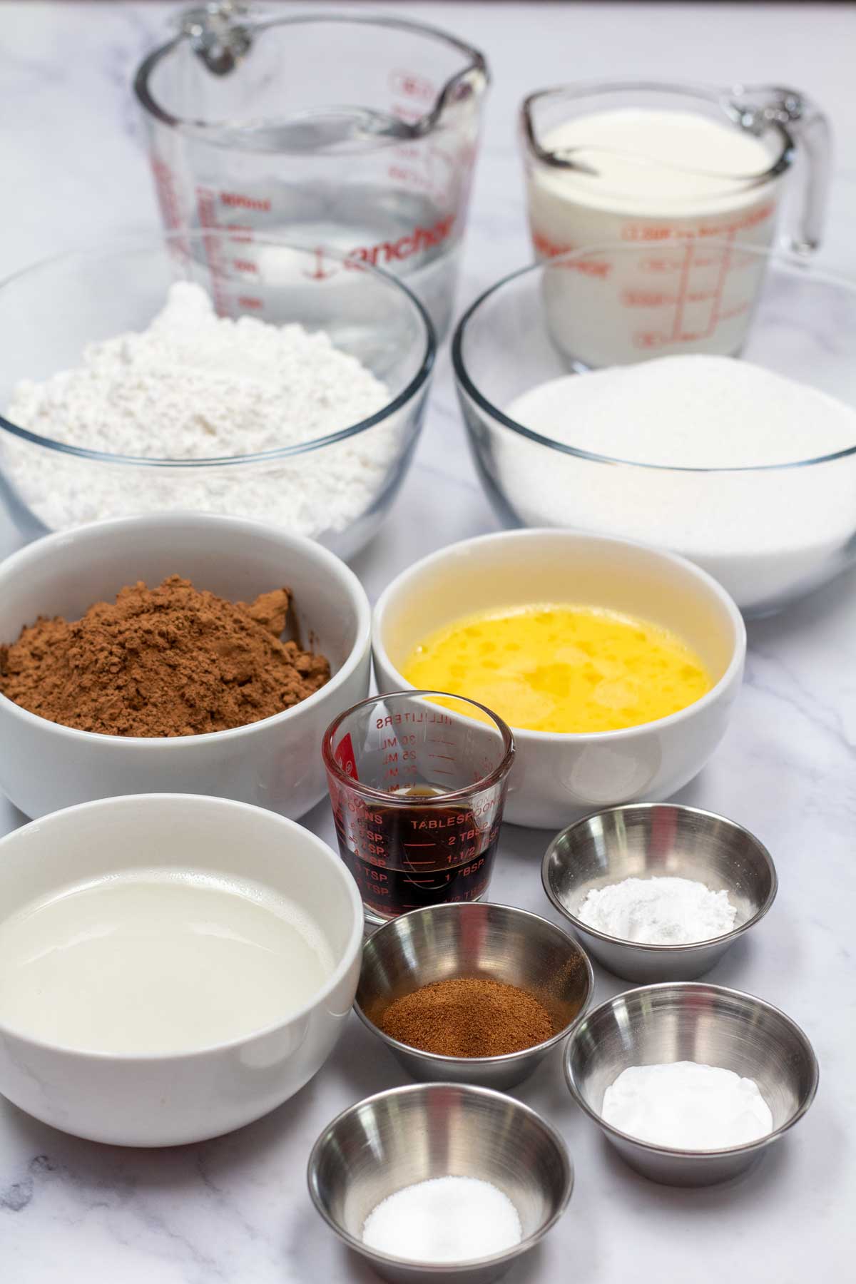 Tall image showing ingredients needed for chocolate cake.