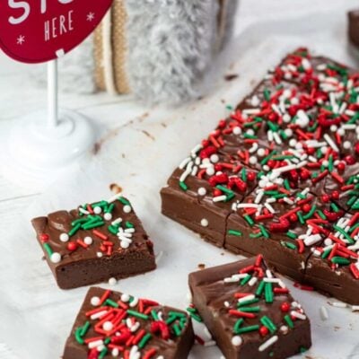 Tall image of Christmas fudge with sprinkles.