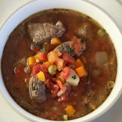 Square image of a bowl of vegetable beef.