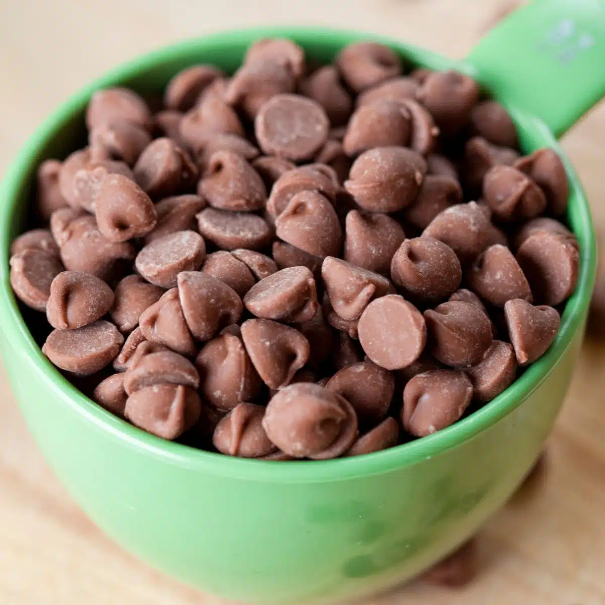 Square image of a cup of chocolate chips.