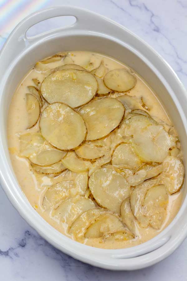 Process image 6 showing transferred au gratin potatoes in a baking dish..
