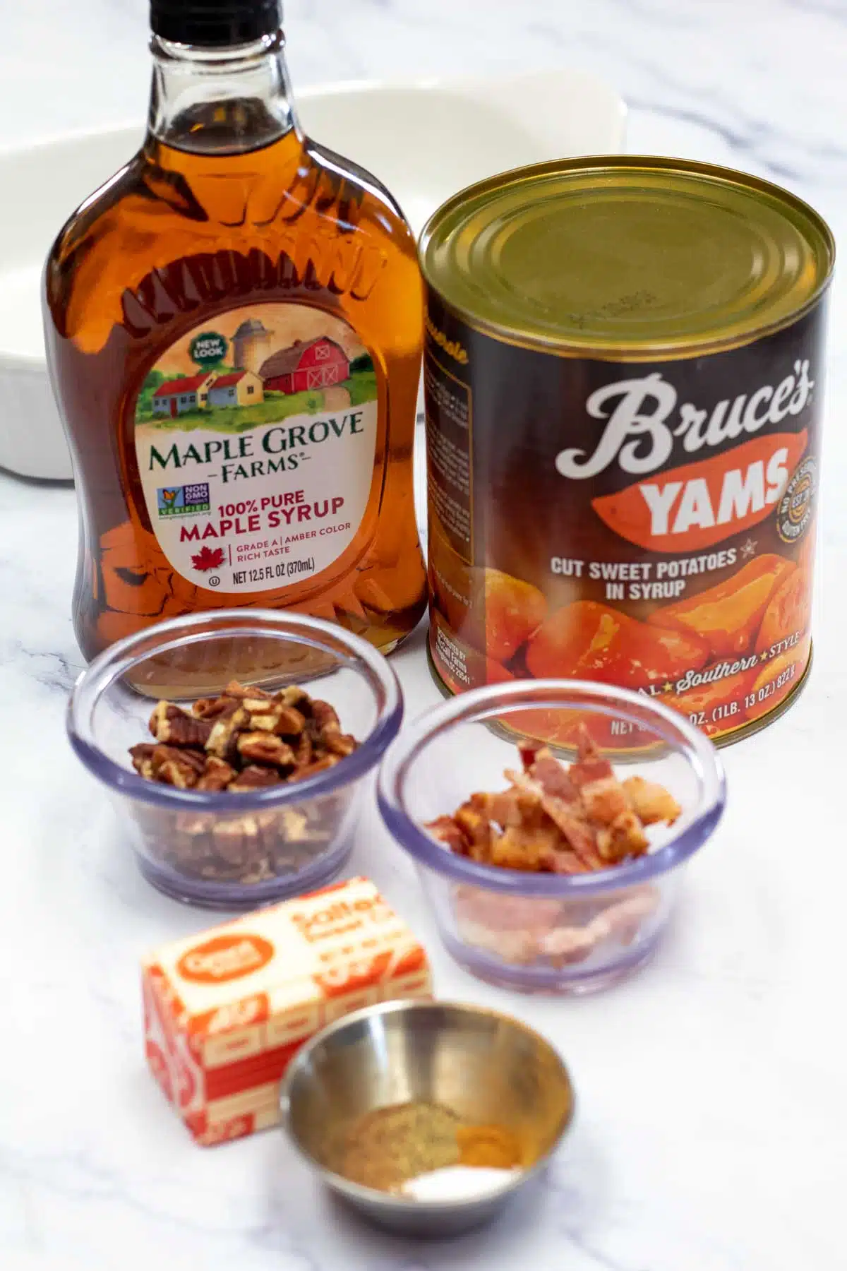 Tall image showing ingredients needed for maple candied yams.