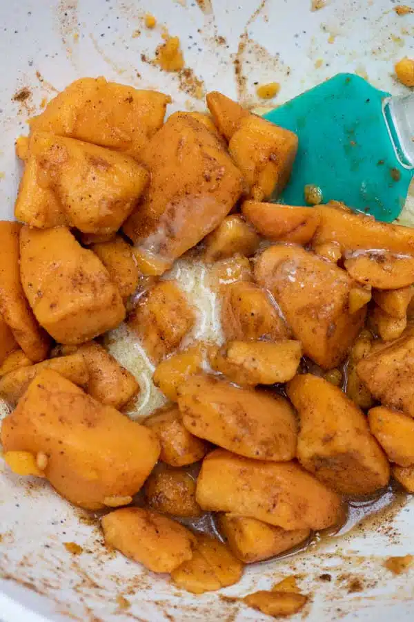 Process image 3 showing yams in a mixing bowl combined with spices.